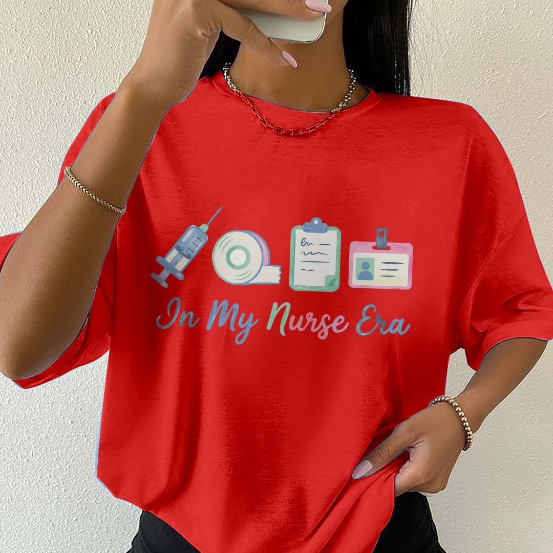 Person wearing a red t-shirt with nurse-themed graphics and text.