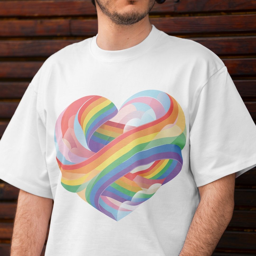 Person wearing a white t-shirt with a colorful heart design against a wooden background