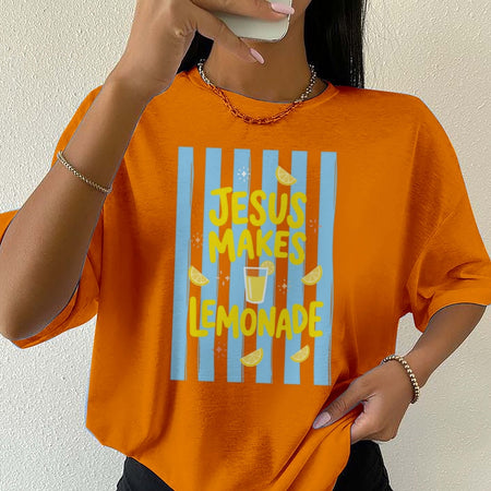 Person wearing an orange t-shirt with 'Jesus Makes Lemonade' design.