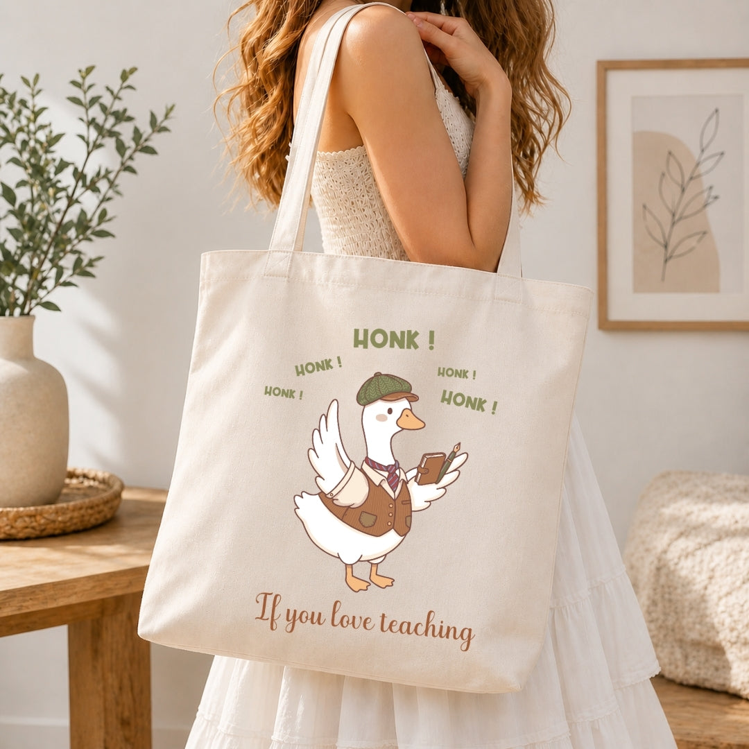 Person in a white dress carrying a canvas tote bag printed with the charming and funny teacher duck design.