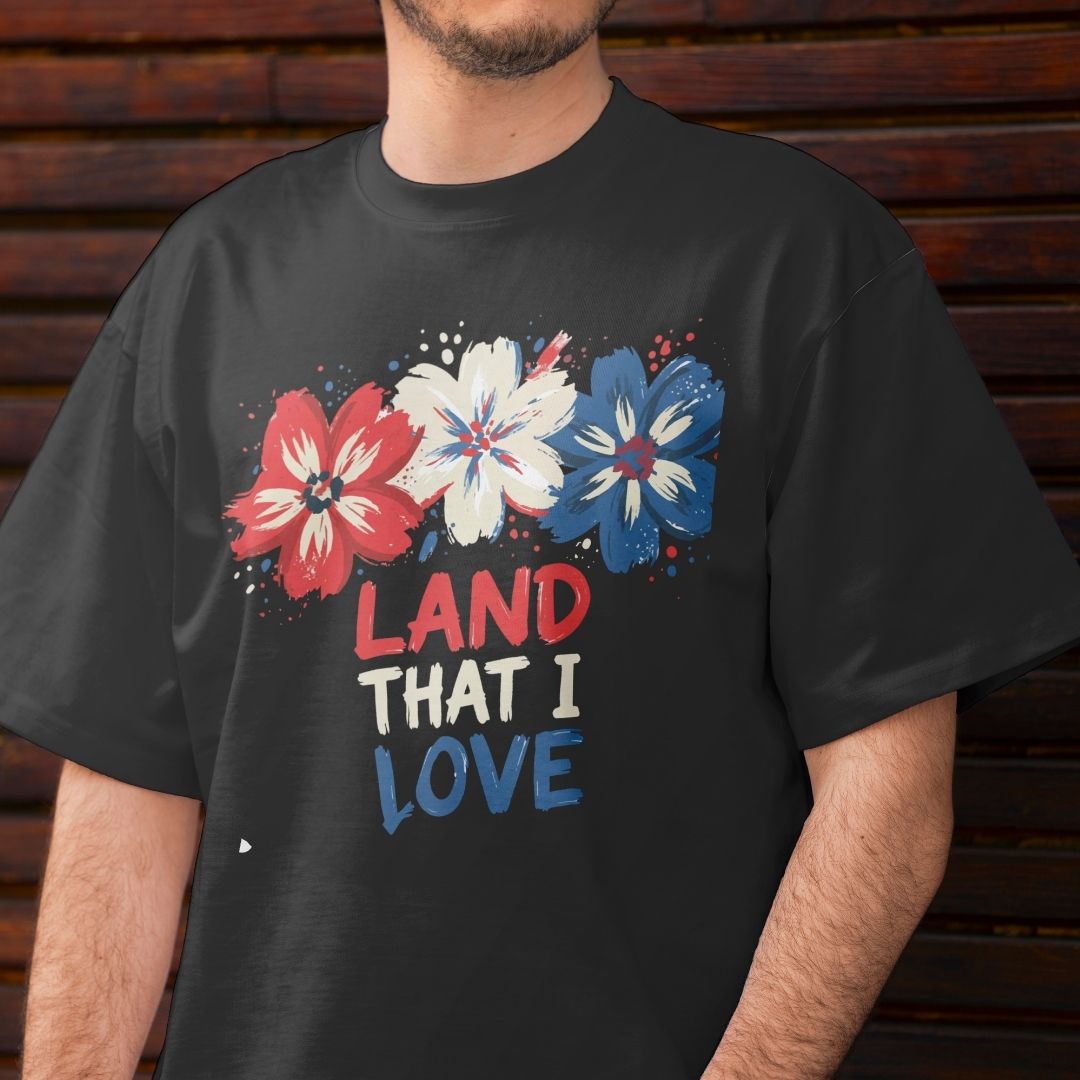 Black t-shirt with red, white, and blue floral design and 'LAND THAT I LOVE' text.