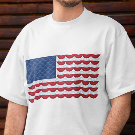White t-shirt with a red, white, and blue pattern resembling an American flag on a wooden background.
