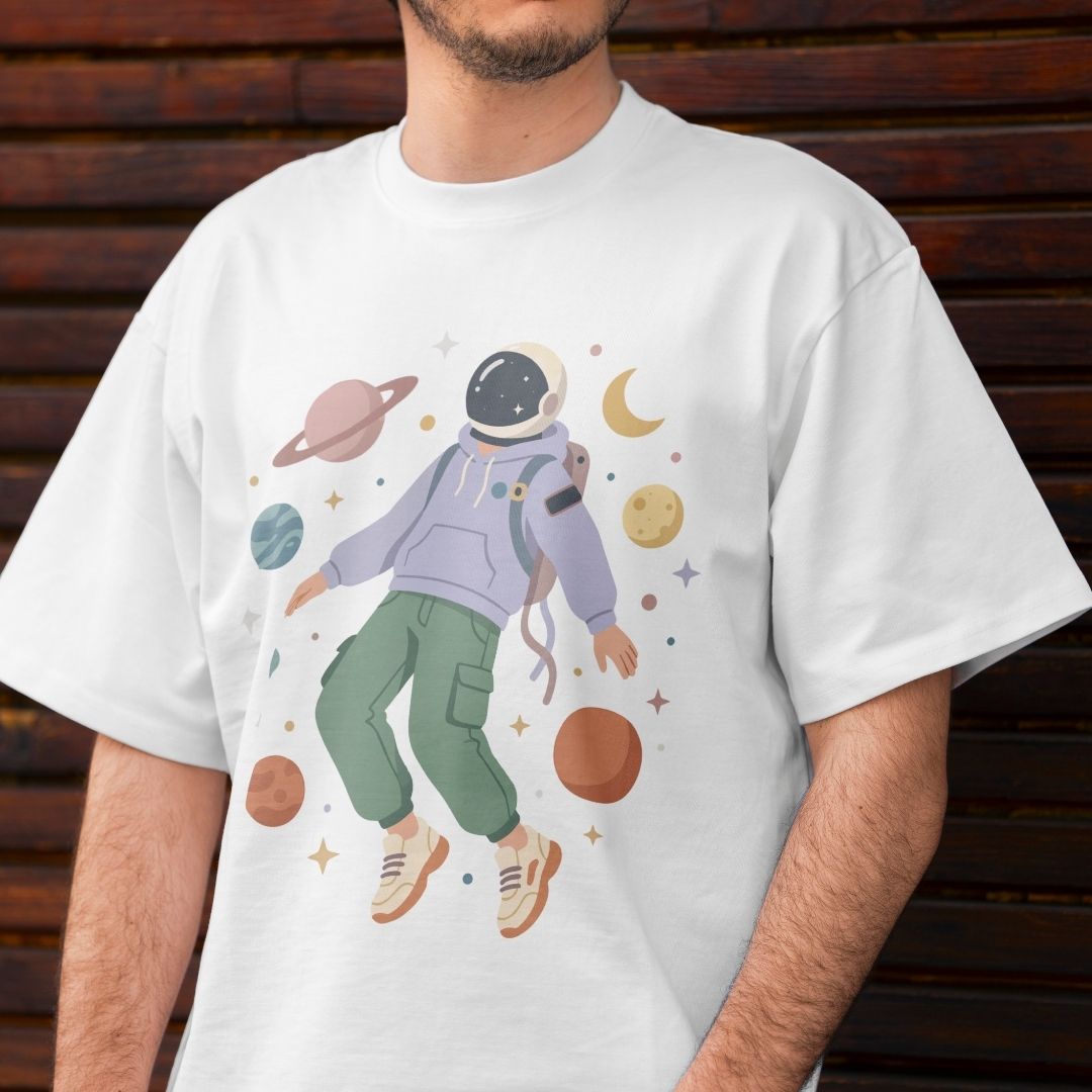 Person wearing a white t-shirt with an astronaut graphic and space-themed design.