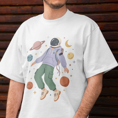Person wearing a white t-shirt with an astronaut graphic and space-themed design.