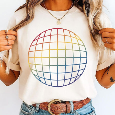 A woman wearing a cream-colored t-shirt with a large, colorful rainbow grid globe graphic on the front, paired with blue jeans and a brown leather belt.