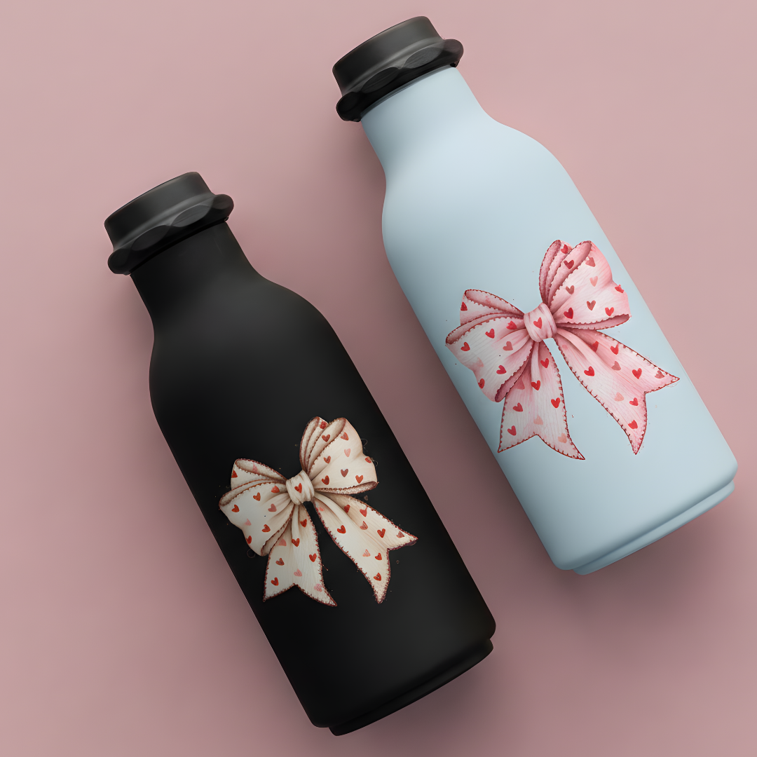 Two water bottles with decorative bows on a pink background