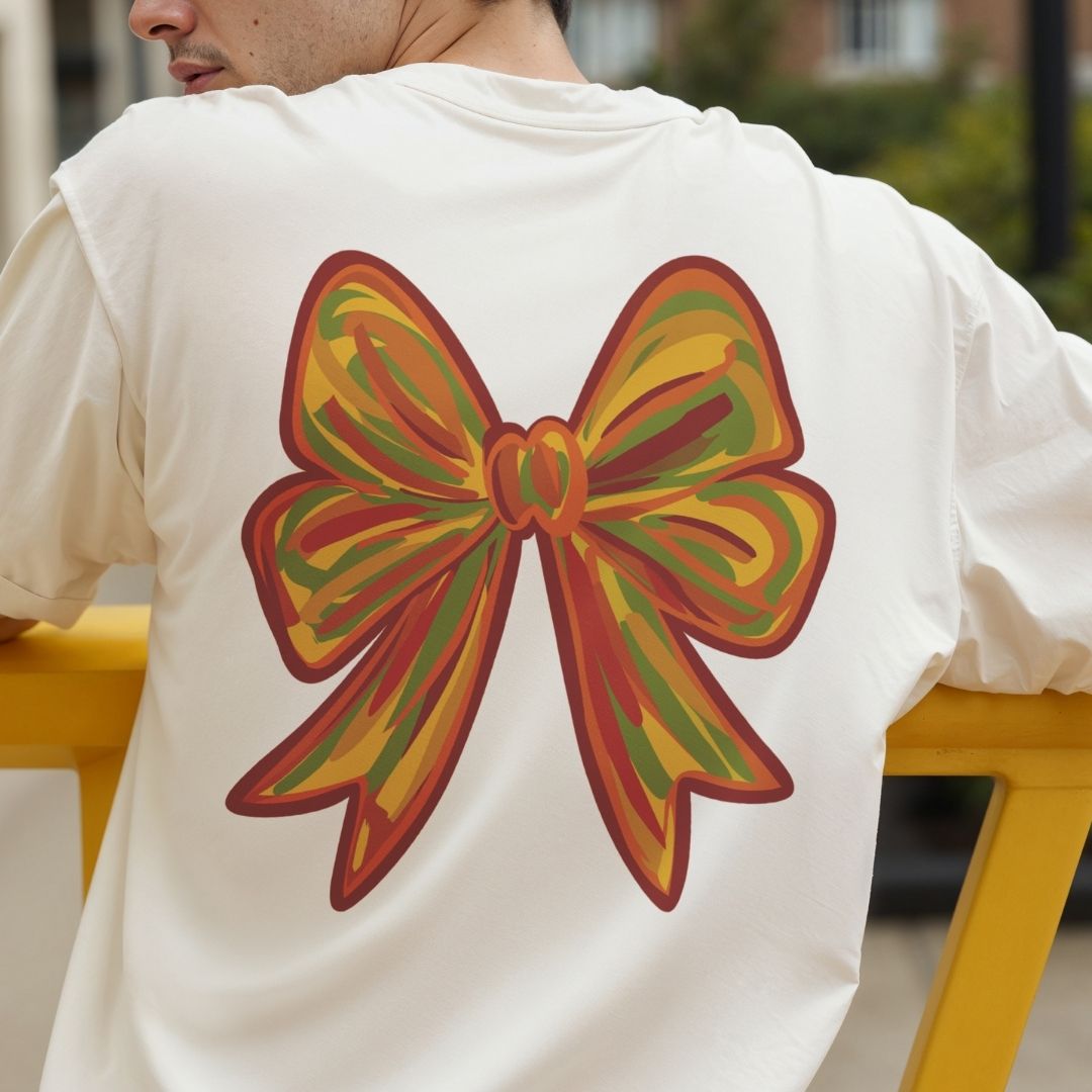 Person wearing a white t-shirt with a colorful bow design on the back.