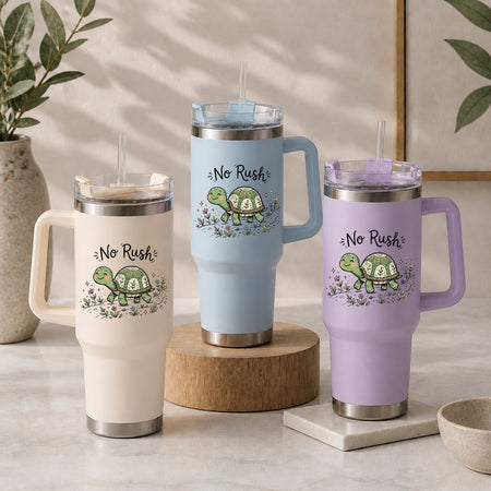 Three insulated tumblers in beige, light blue, and purple, each featuring the cute "No Rush" turtle illustration among flowers.