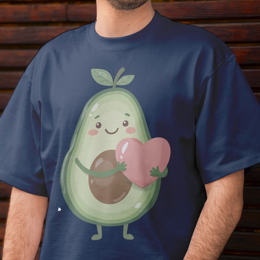 Person wearing a navy blue t-shirt with a cartoon avocado holding a heart.