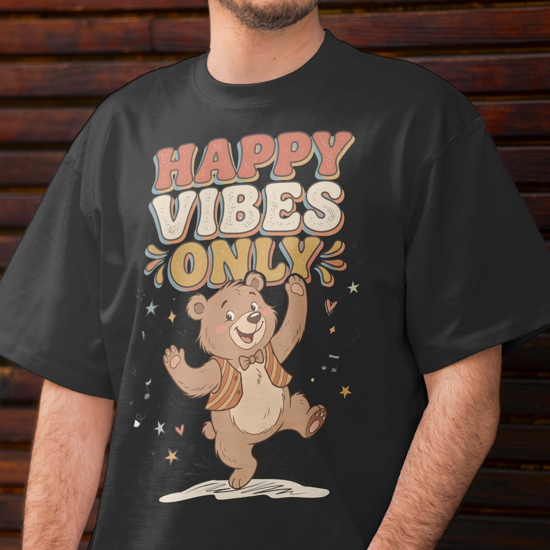 Person wearing a black t-shirt with a bear graphic and 'Happy Vibes Only' text against a wooden background