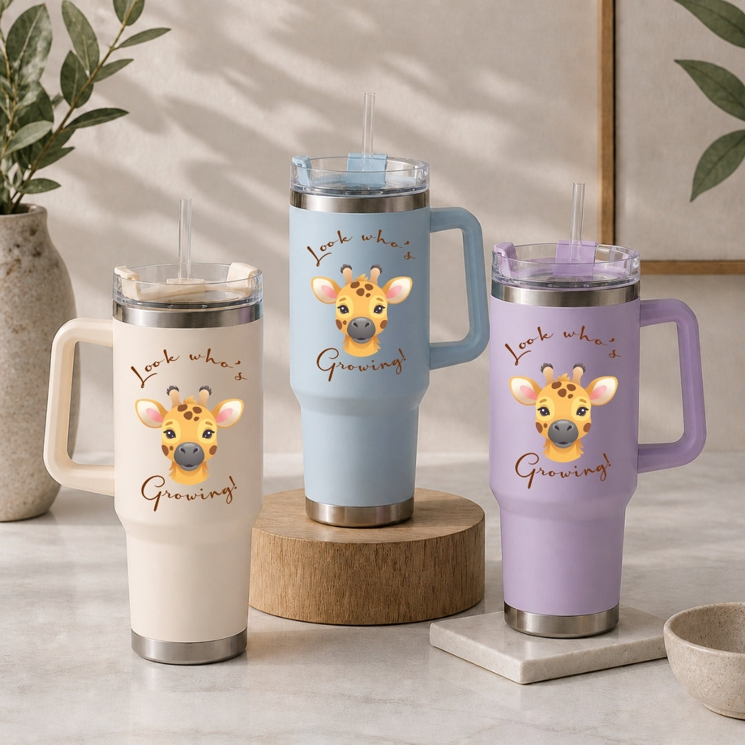 Three large insulated travel tumblers with straws in cream, light blue, and lavender, each printed with the cute giraffe Look Whos Growing graphic.