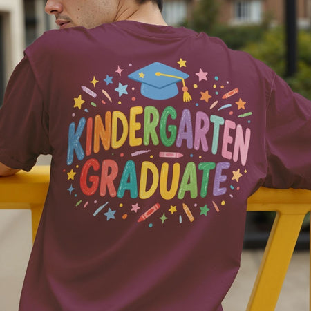 Person wearing a purple t-shirt with 'Kindergarten Graduate' text and graphics.
