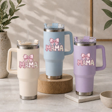 Three insulated travel tumblers with handles and straws in cream, light blue, and lavender, all customized with a decorative pink "MAMA" bow illustration.
