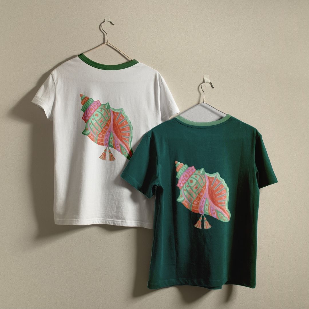 Two t-shirts, one white and one green, with a colorful shell design on a beige background.