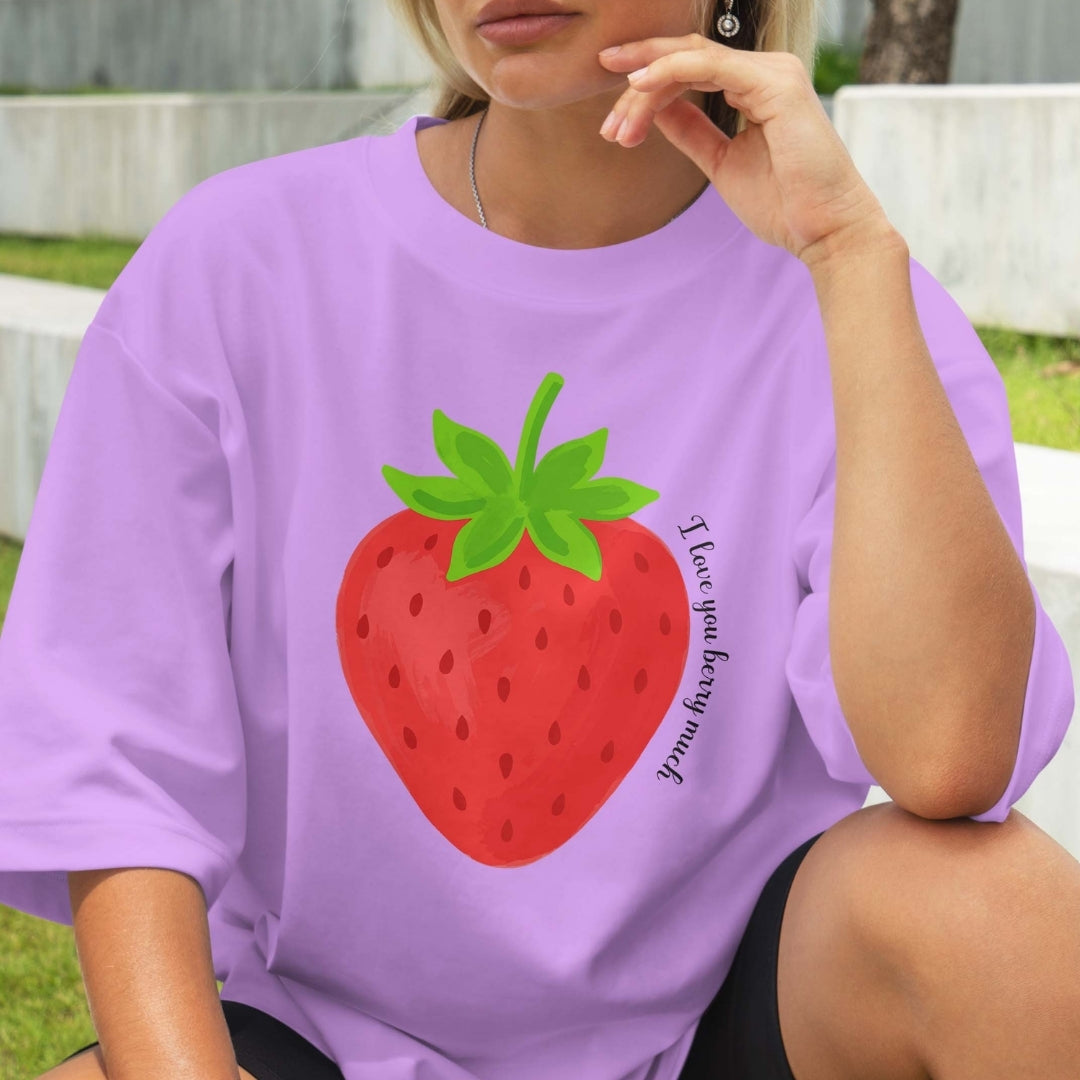 Person wearing a purple t-shirt with a strawberry graphic and text.