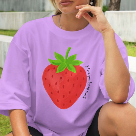 Person wearing a purple t-shirt with a strawberry graphic and text.