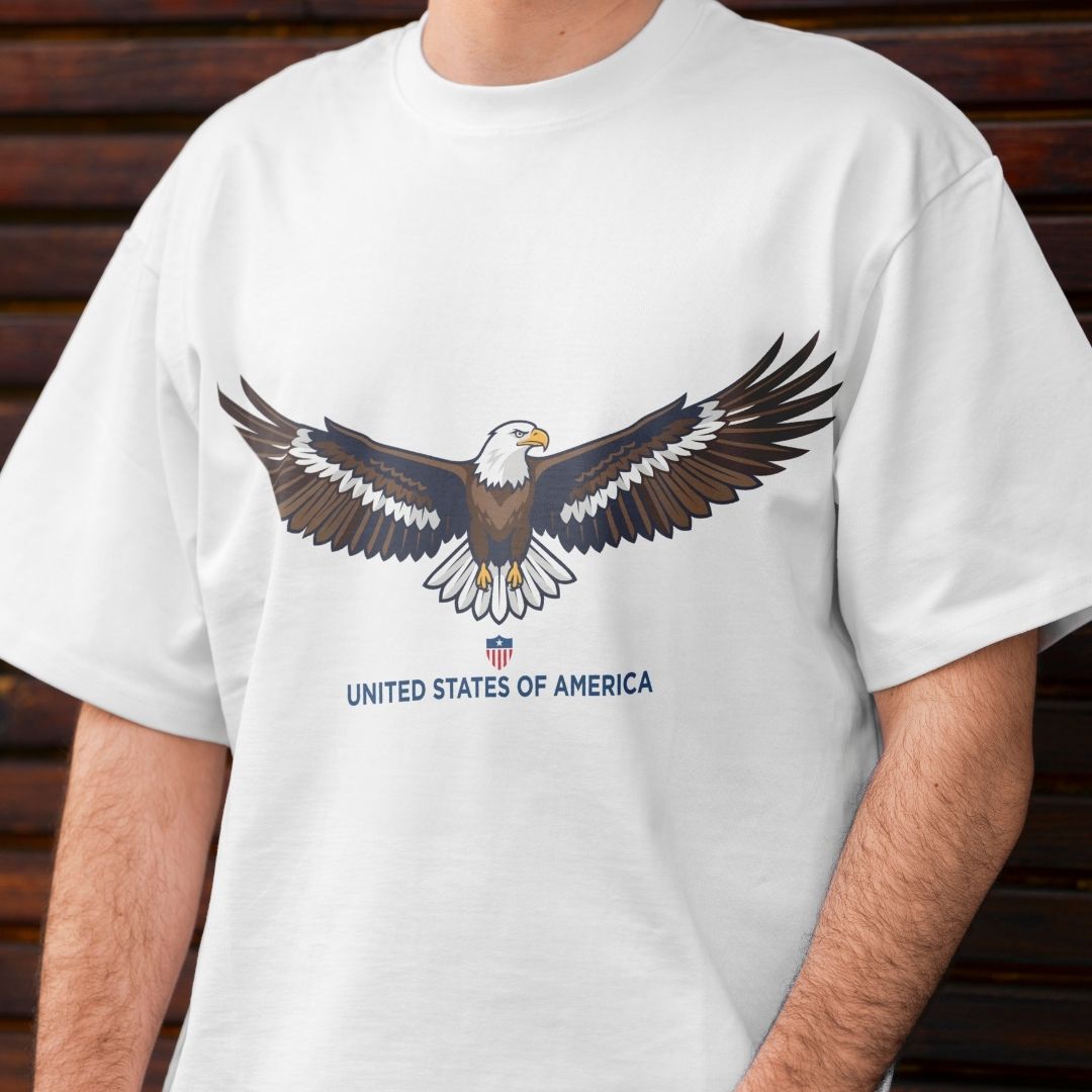 White t-shirt with an eagle graphic and 'United States of America' text on a wooden background