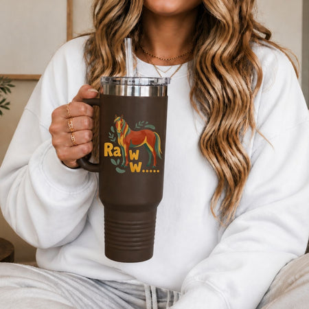 A woman holding a large brown travel tumbler with a handle and clear straw, featuring the "Raww..." horse digital design asset.
