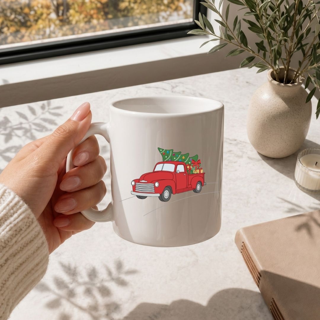 Hand holding a mug with text on a table with a window and plant in the background