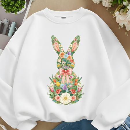 White sweatshirt with floral bunny design on a neutral background
