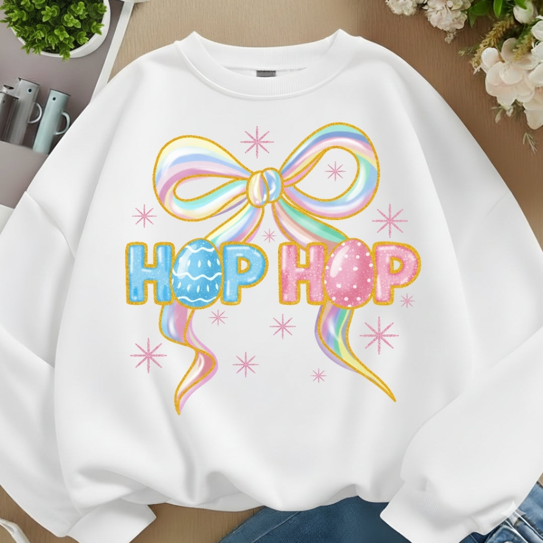 White sweatshirt with colorful bow and 'Hop Hop' text on a neutral background
