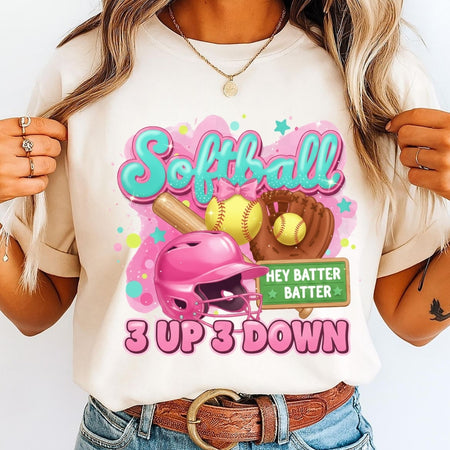 Person wearing a t-shirt with a colorful softball design and text.