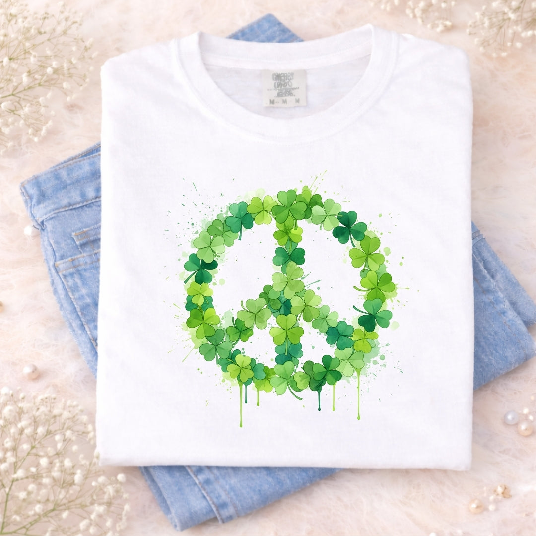 White t-shirt with a green peace symbol made of leaves on a light background