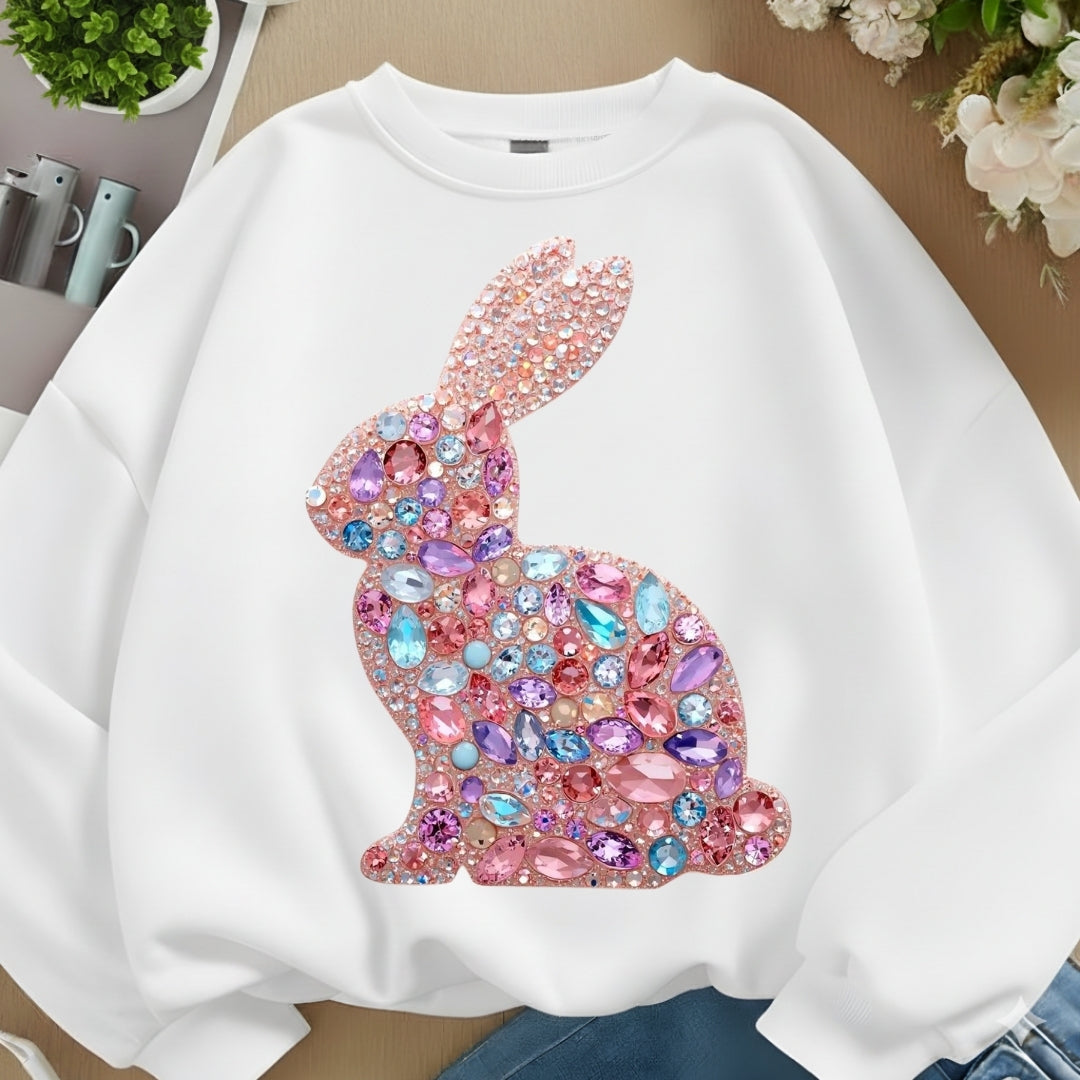 White sweatshirt with a colorful rabbit design on a neutral background