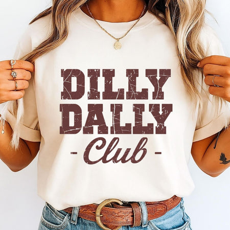 Person wearing a white t-shirt with 'Dilly Dally Club' text design.