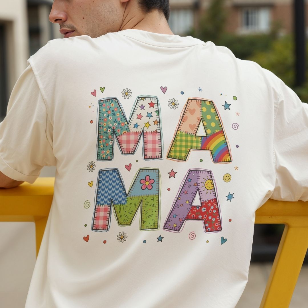 Person wearing a white t-shirt with colorful 'MAMA' text design.