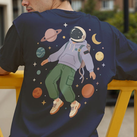 Person wearing a navy blue t-shirt with an astronaut graphic on the back.