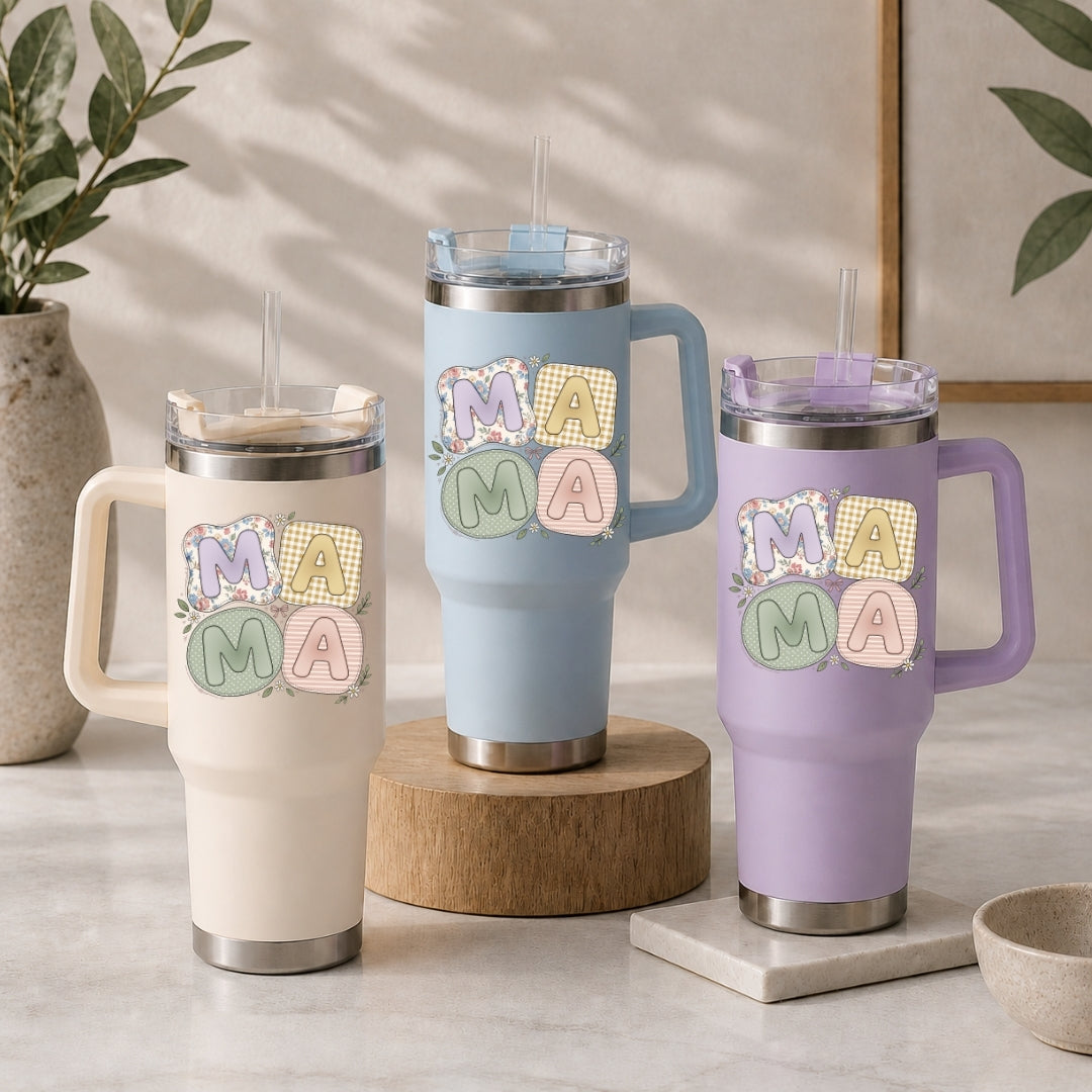 Three insulated tumblers in beige, light blue, and purple, each featuring the pastel patchwork "MAMA" illustration.