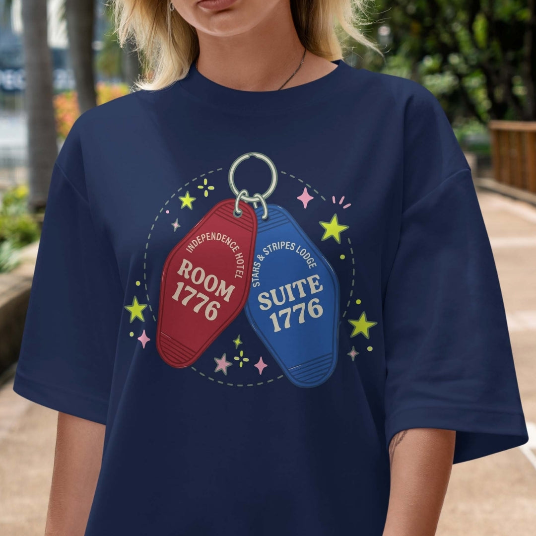 Person wearing a navy blue t-shirt with room and suite keychain design.
