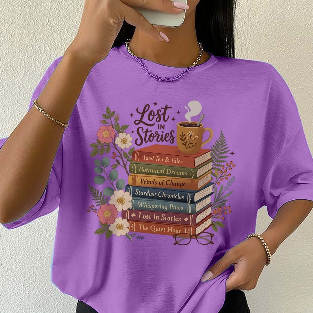 Person wearing a purple t-shirt with book-themed design and text.