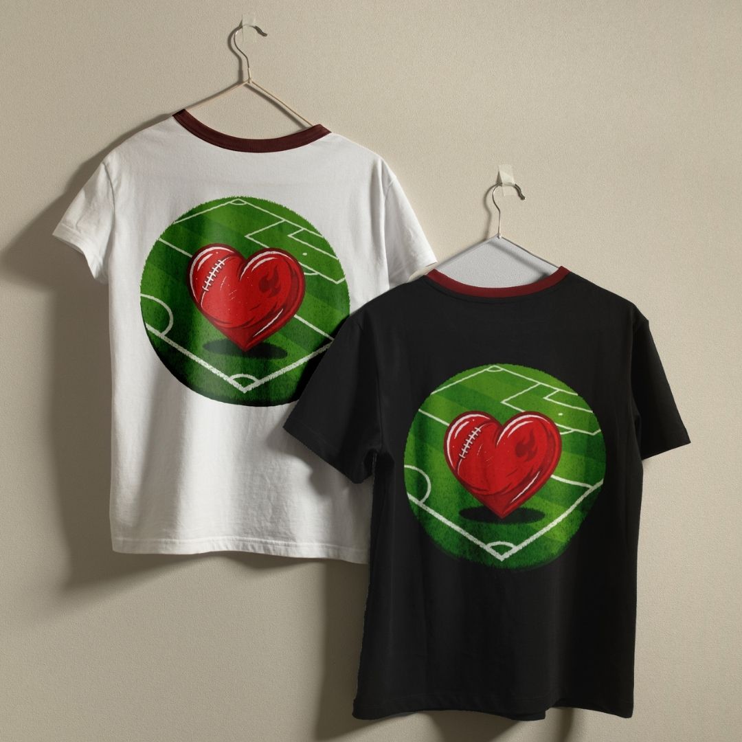 Two t-shirts, one white and one black, with a red heart and green field design on a beige background.