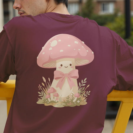 Person wearing a maroon t-shirt with a cartoon mushroom design on the back.
