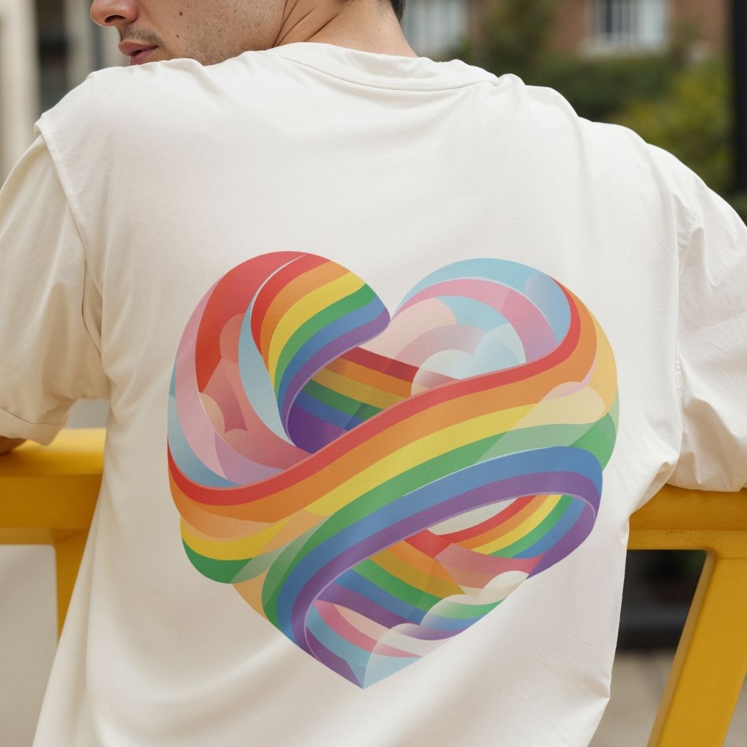 Person wearing a white t-shirt with a colorful rainbow heart design on the back.