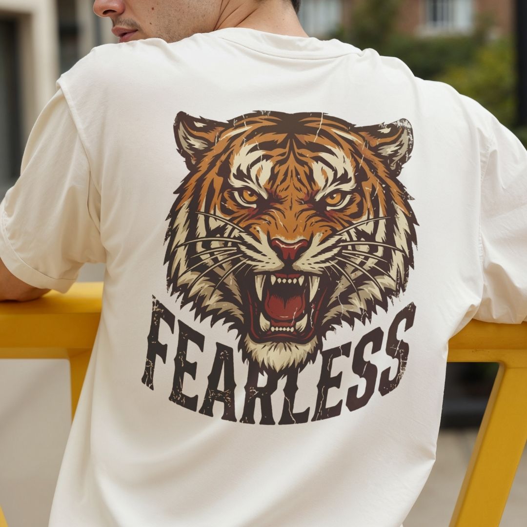 Person wearing a white t-shirt with a tiger graphic and 'FEARLESS' text.