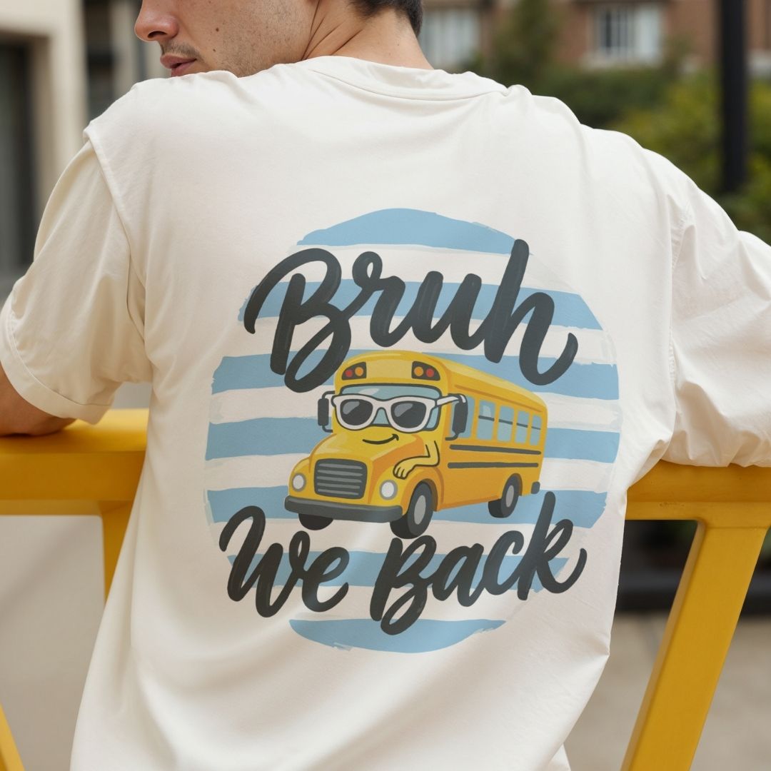 Person wearing a white t-shirt with a yellow school bus graphic and text on the back.