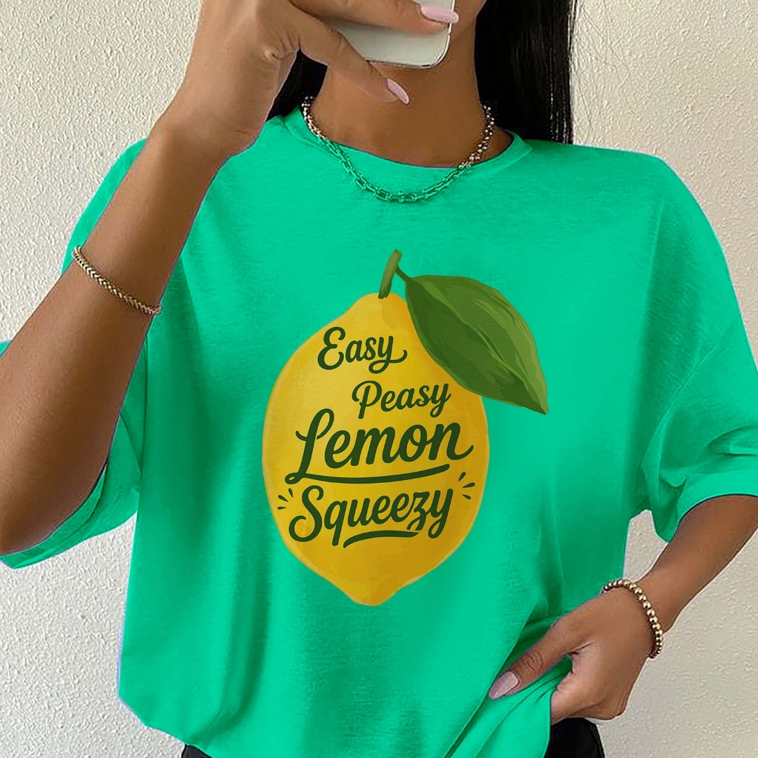 Person wearing a green t-shirt with a lemon graphic and text.