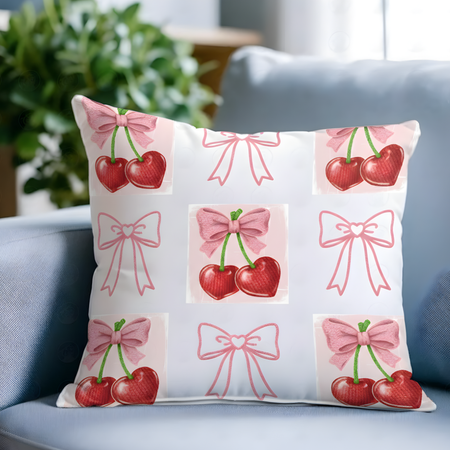 Decorative pillow with cherry and bow pattern on a blue couch