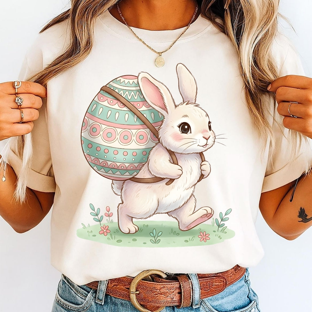 Person wearing a t-shirt with a bunny and Easter egg design.