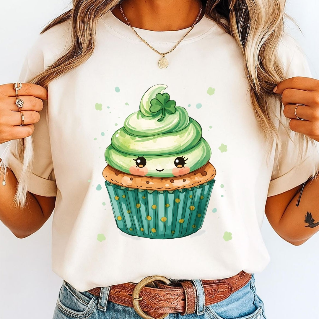 Person wearing a t-shirt with a cartoon cupcake design on a white background