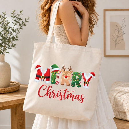 Woman holding a canvas tote bag printed with a festive "MERRY Christmas" holiday graphic.