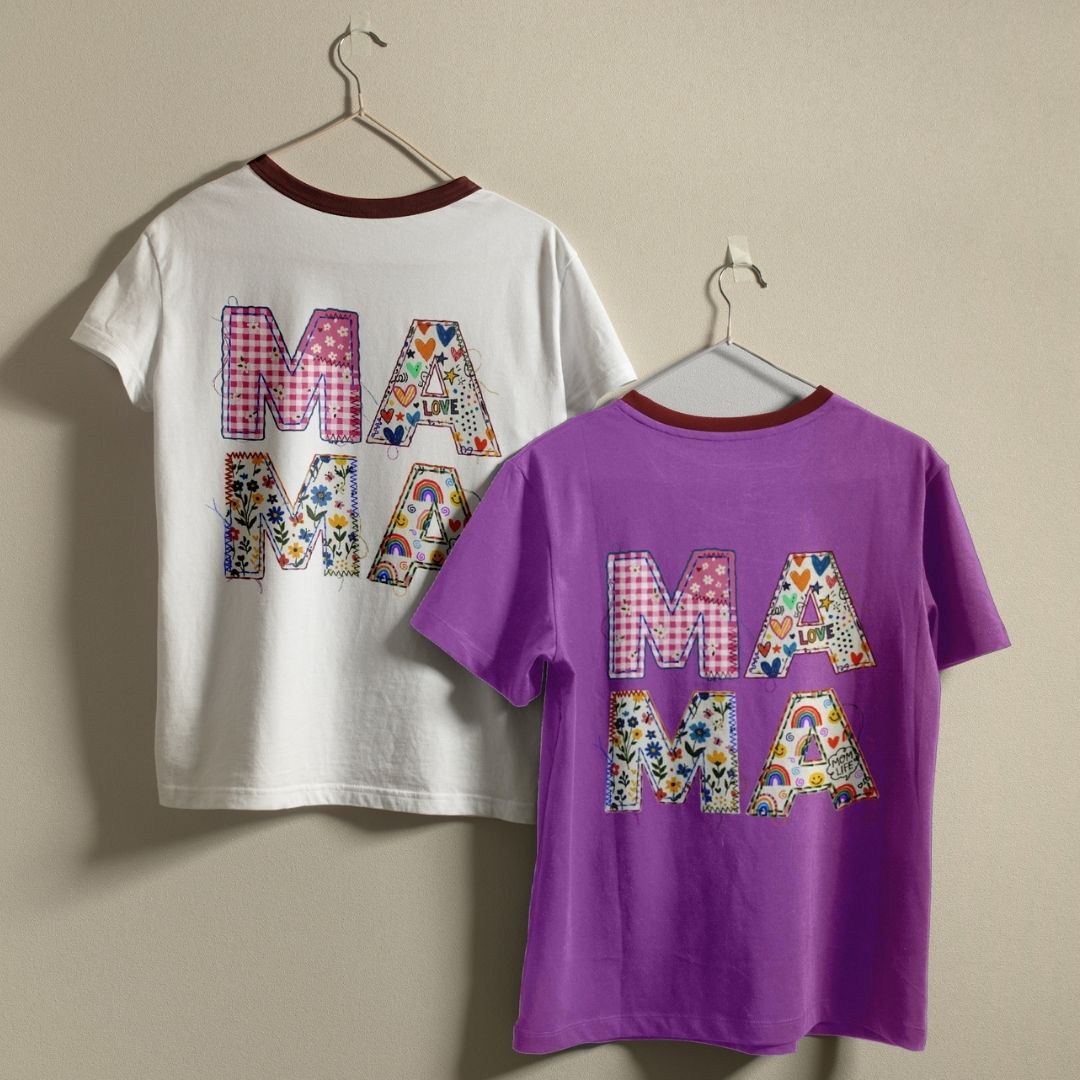 White and purple t-shirts with floral 'MAMA' text on hangers against a beige background