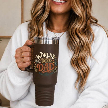 Person holding a brown mug with 'World's Best Dad' text, smiling.