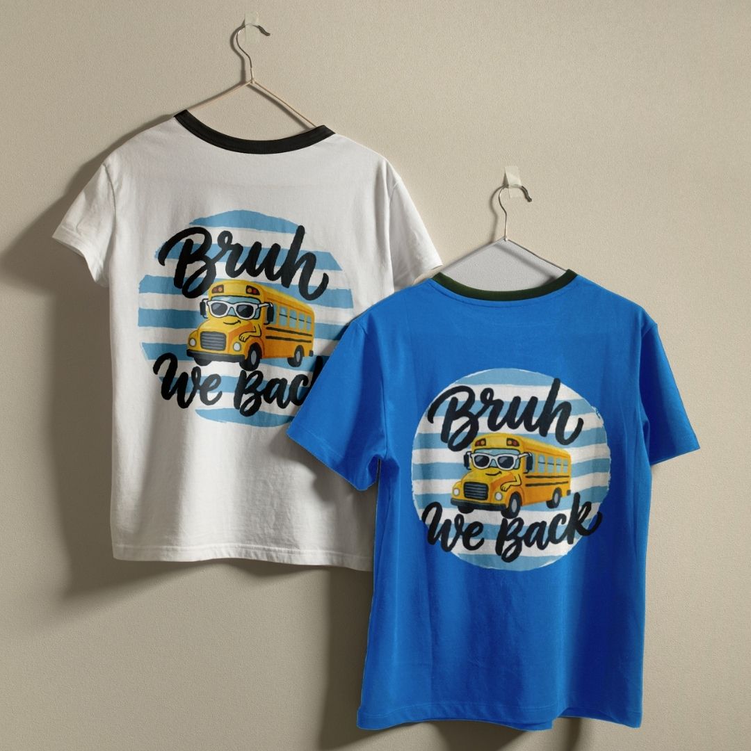 Two t-shirts with a school bus graphic and text on hangers against a beige background.
