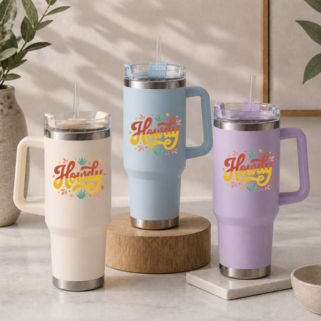 Three insulated travel mugs with 'Howdy' text on a neutral background