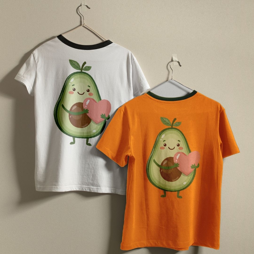 Two t-shirts, one white and one orange, with a cartoon avocado design holding a heart on a beige background.