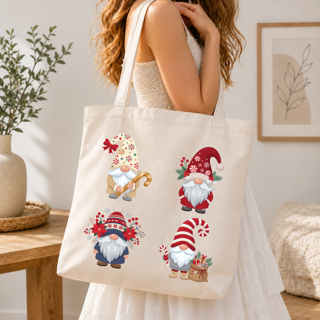Woman holding a canvas tote bag printed with a festive Christmas gnomes holiday graphic.